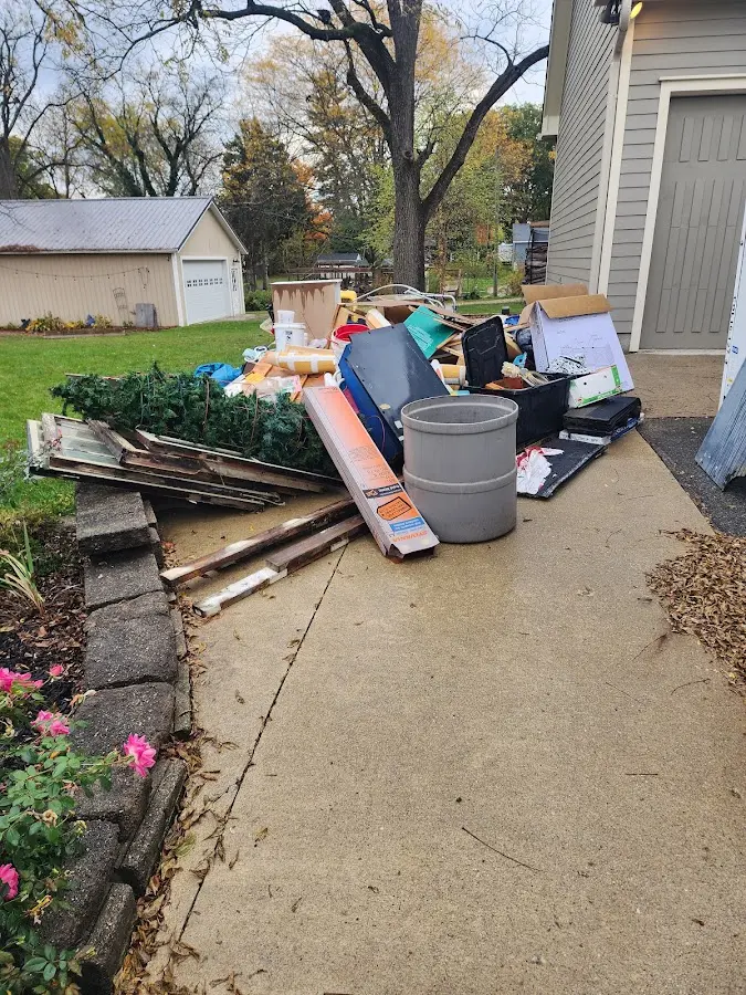 Dumpster being loaded with debris for Estate Cleanout Dumpster Rental in Monroeville